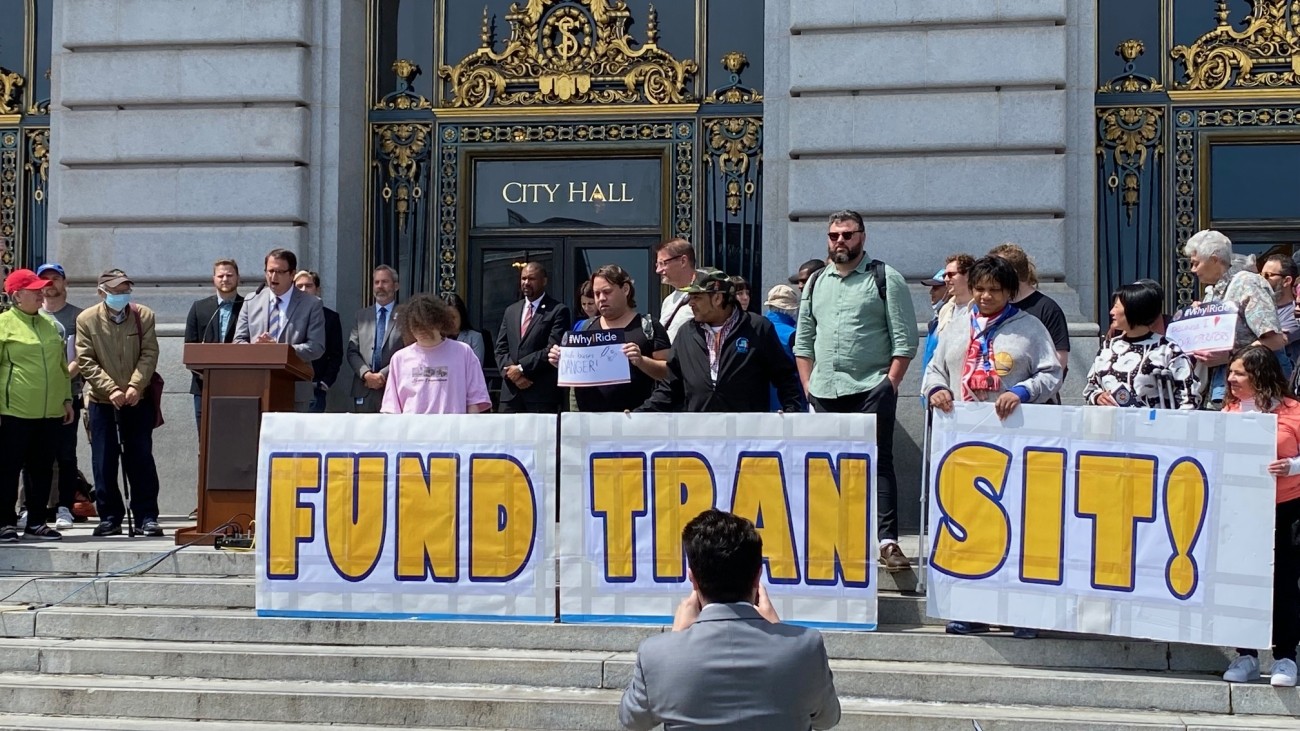 City leaders and advocates at a rally to prioritize transit funding, on the steps of San Francisco's City Hall 