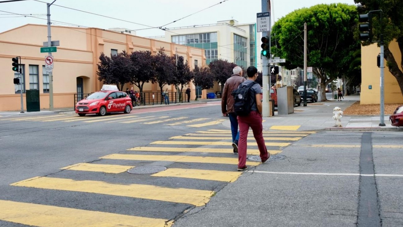 Pedestrians cross the street at Church and 16th Streets. 