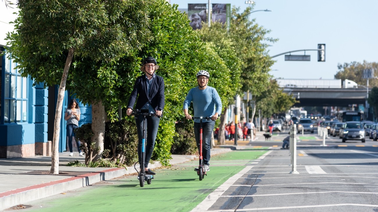 People on scooters in a bike lane