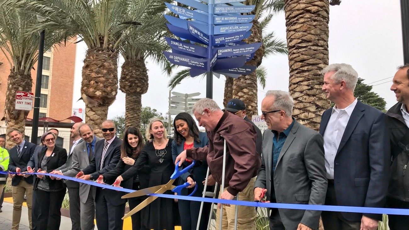 Elected officials cutting a ribbon at Geary and Masonic