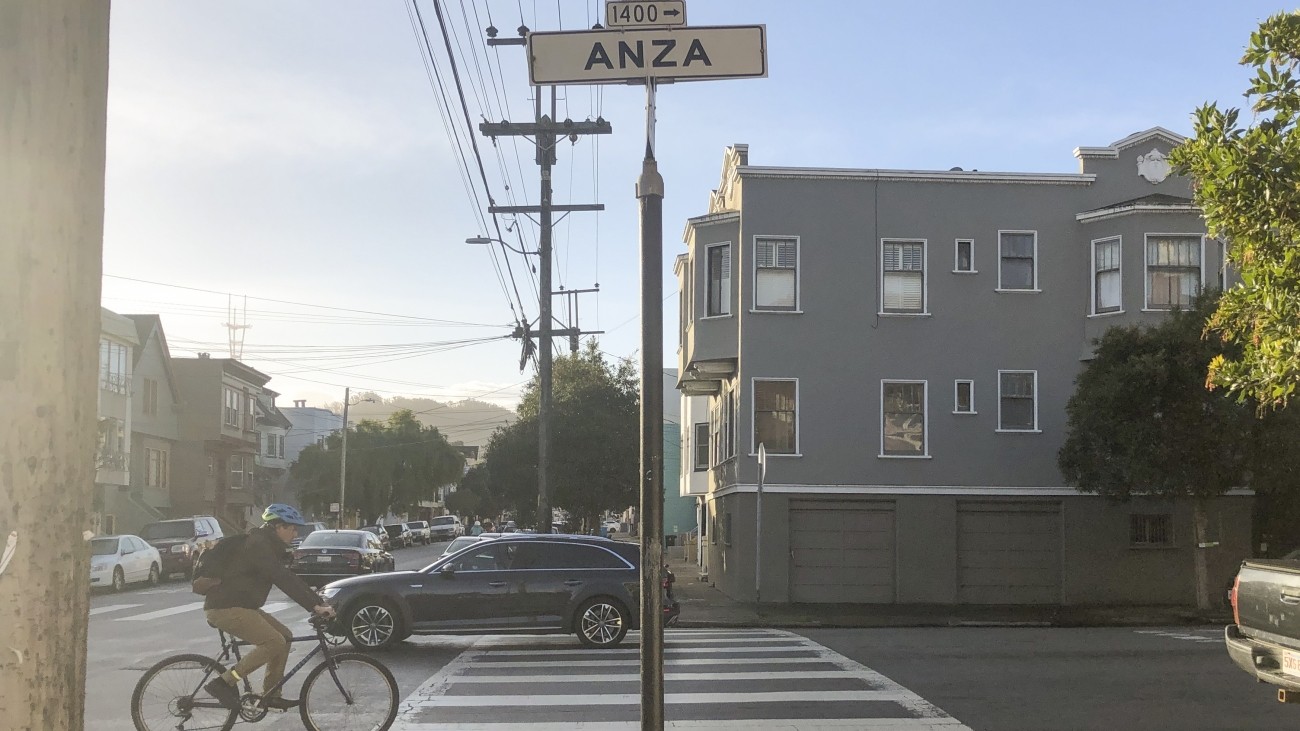 A bicyclist riding on Anza Street