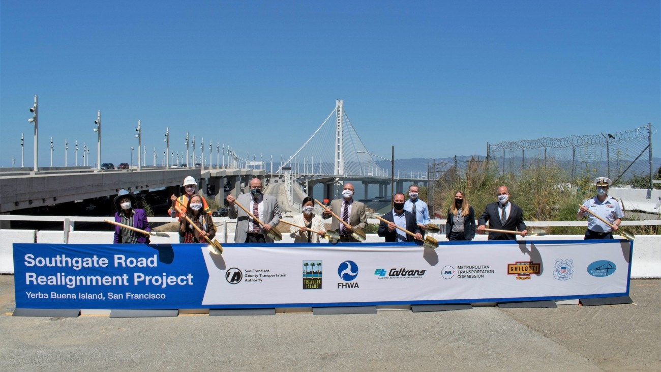 project managers holding up banner