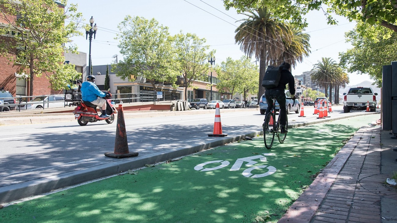 Bicyclist on green painted bicycle path in Upper Market Street