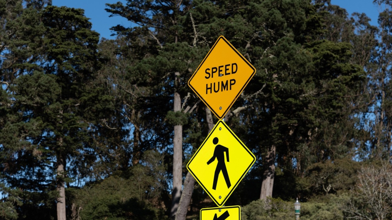 Speed hump and pedestrian crossing traffic signs