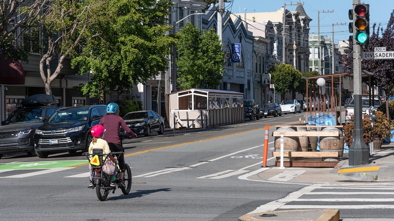 Bicyclist with child on bike on road