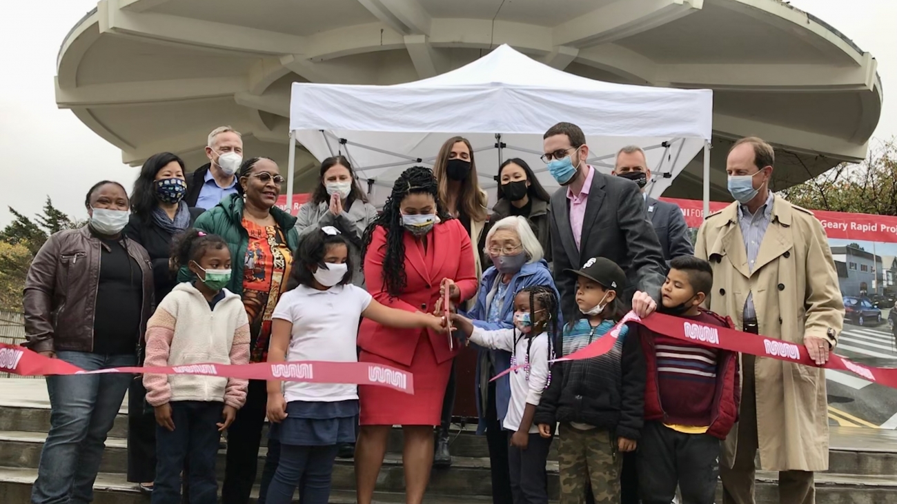 City officials, transportation agency staff, and community members gathered around the ribbon cutting in front of the Japantown Peace Plaza.