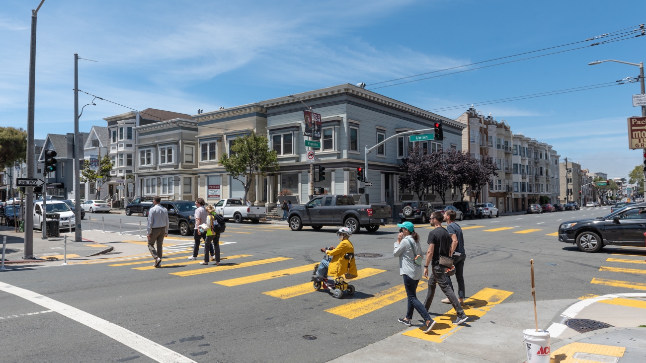 Pedestrians and wheelchair user in crosswalk by Franklin and Union Streets