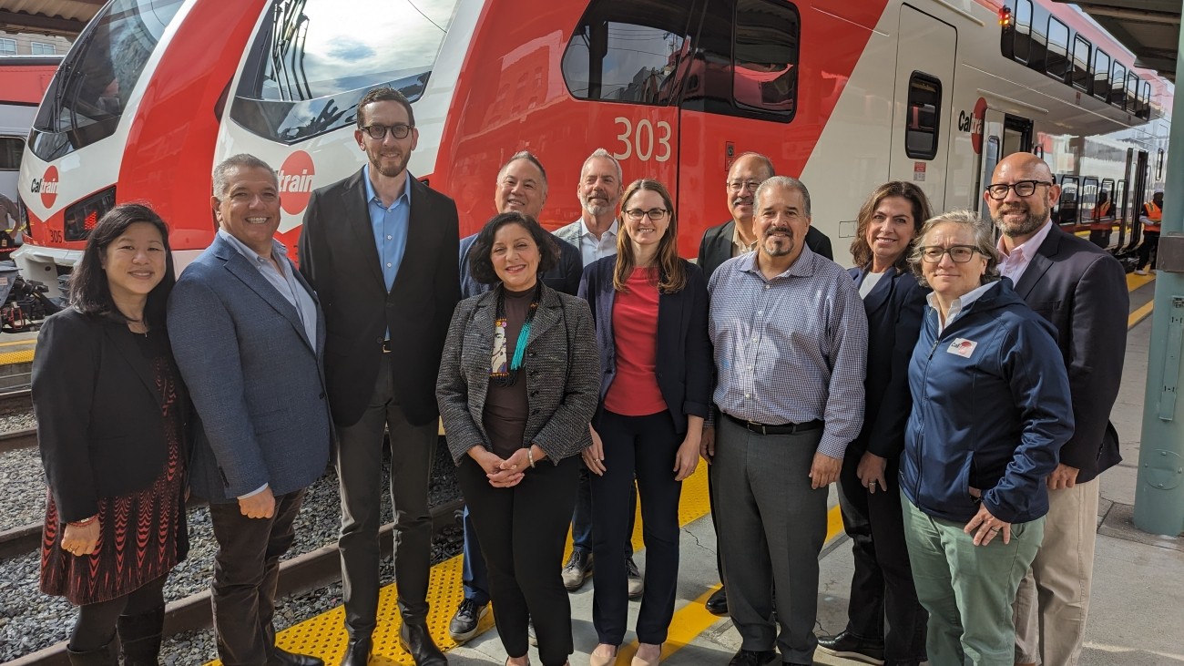 Group shot in front of new electric train