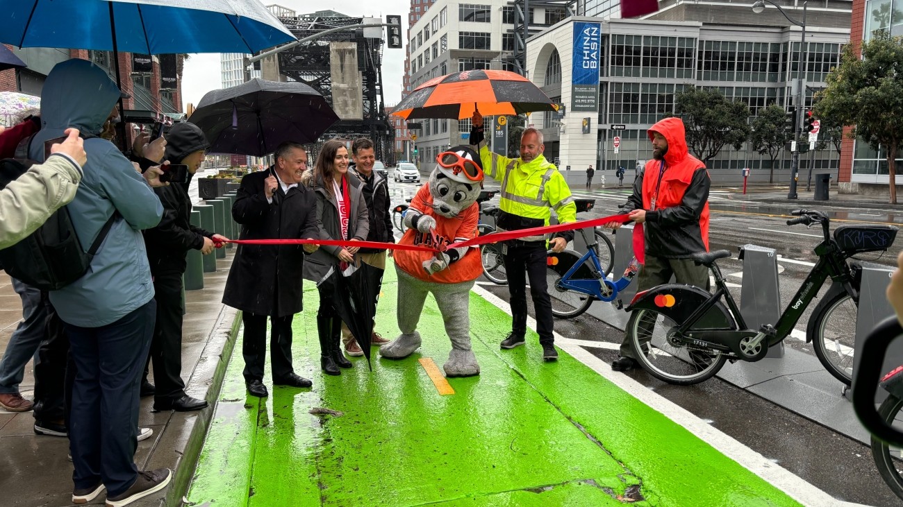 Lou Seal and officials open new protected bike lane on 3rd Street near Berry Street. 