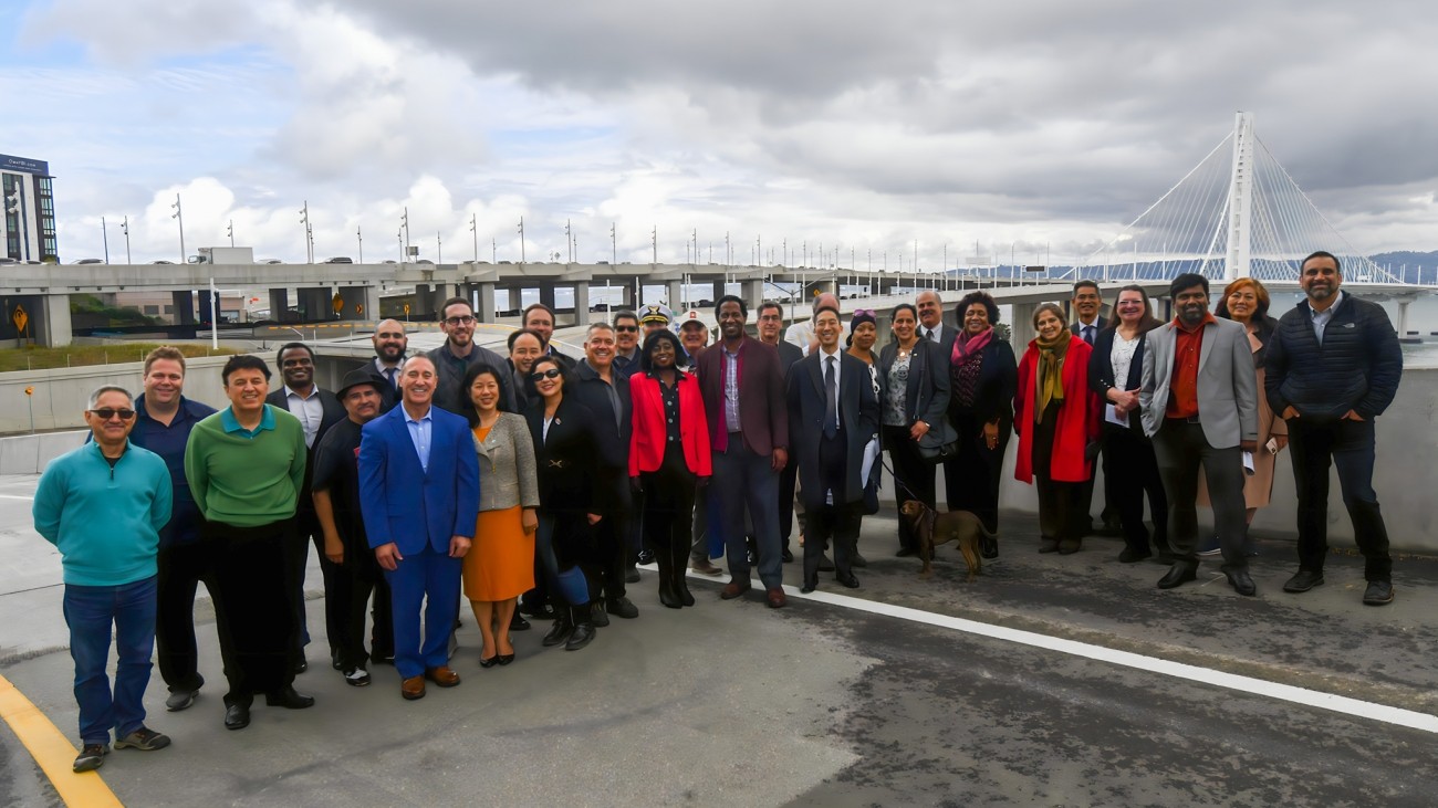 A large group of people pose in front of the newly-completed Yerba Buena Island / I-80 Southgate Road and Interchange Project