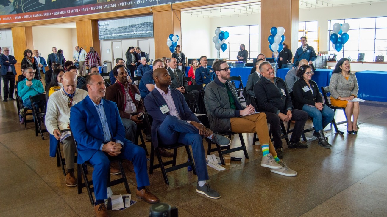 VIPs watch a speaker at the Yerba Buena Island / I-80 Southgate Road and Interchange Project ribbon-cutting ceremony.