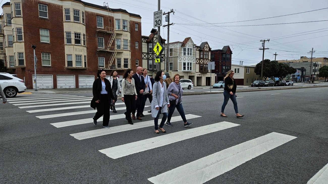 People walking in a crosswalk along Geary Blvd and 38th Ave