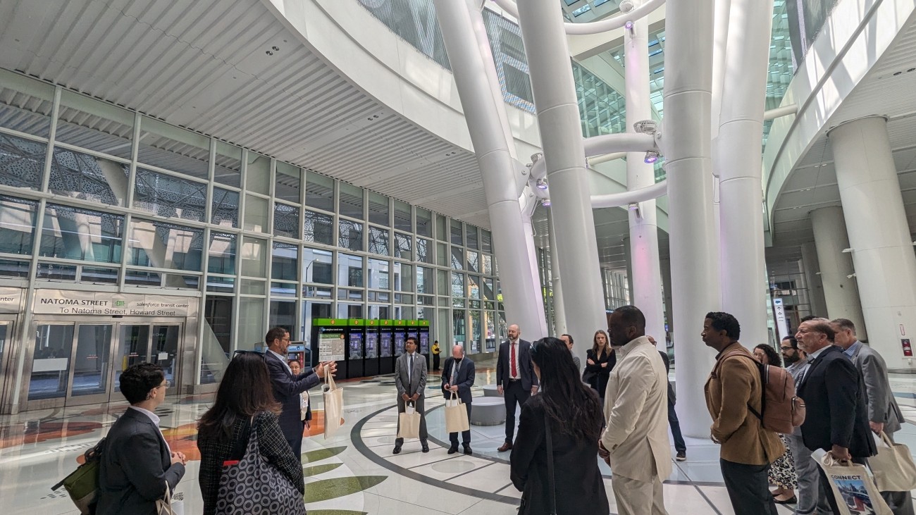 People standing around a speaker at the Salesforce Transit Center