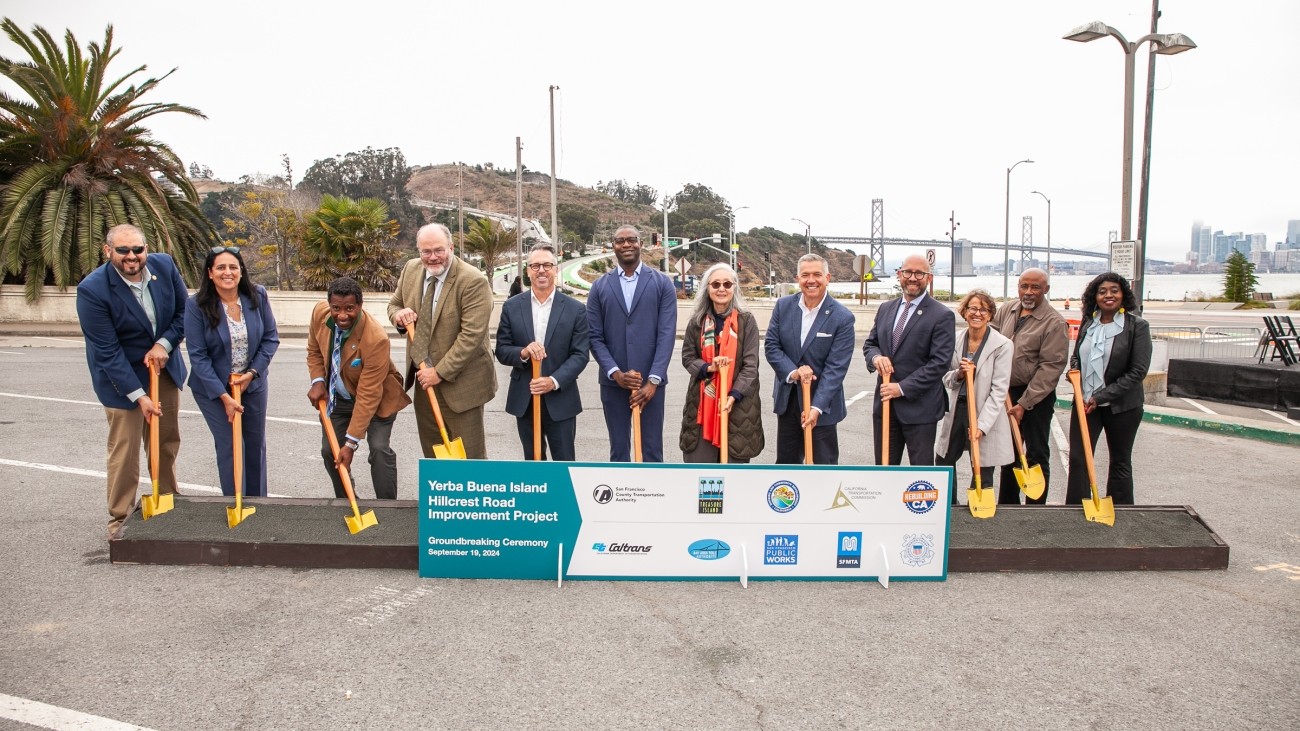 Transportation officials, community leaders and staff posing for a photo with shovels