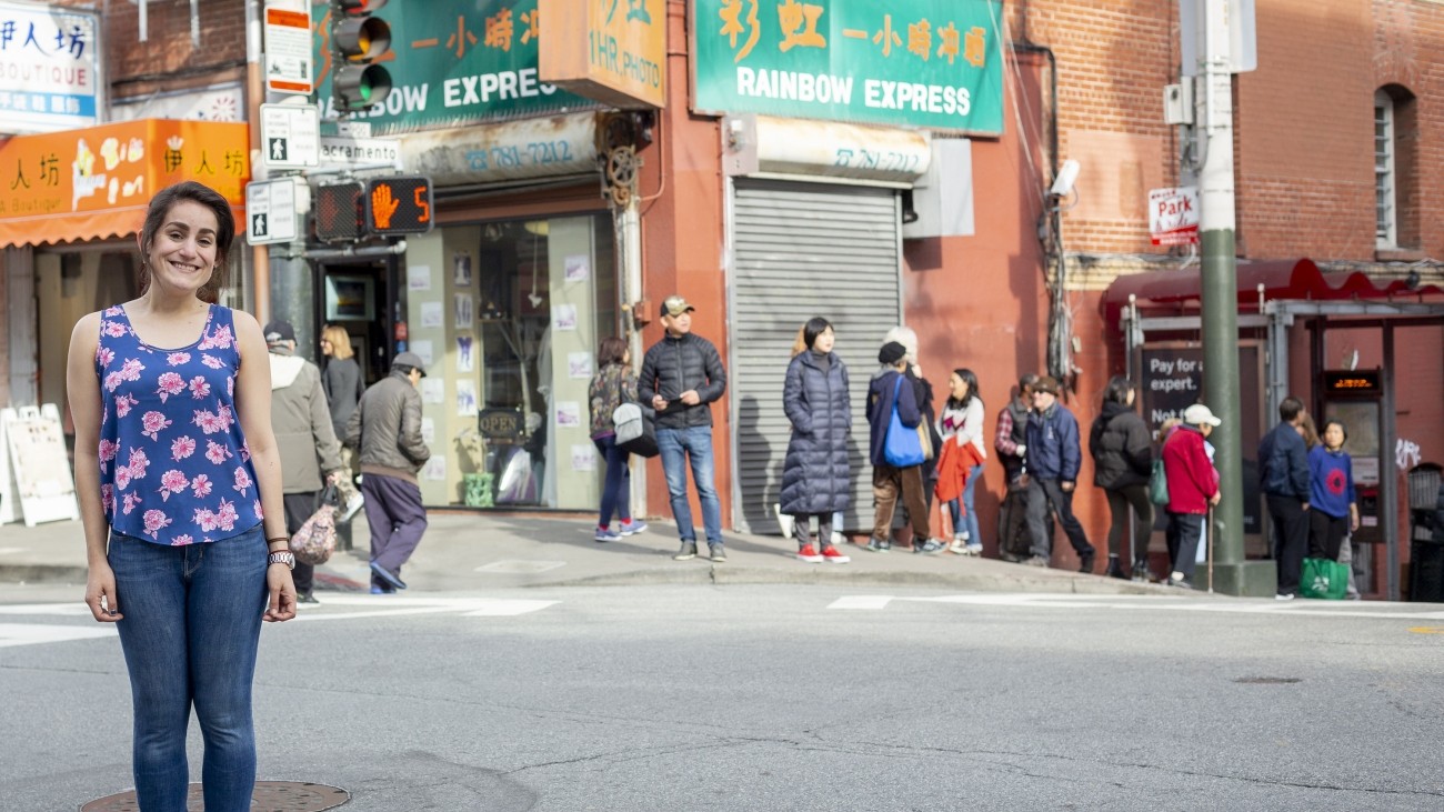 A woman standing by a busy intersection