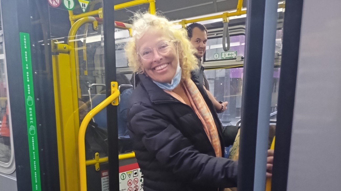 Transit rider stands at the entrance to the 49 Muni bus. 