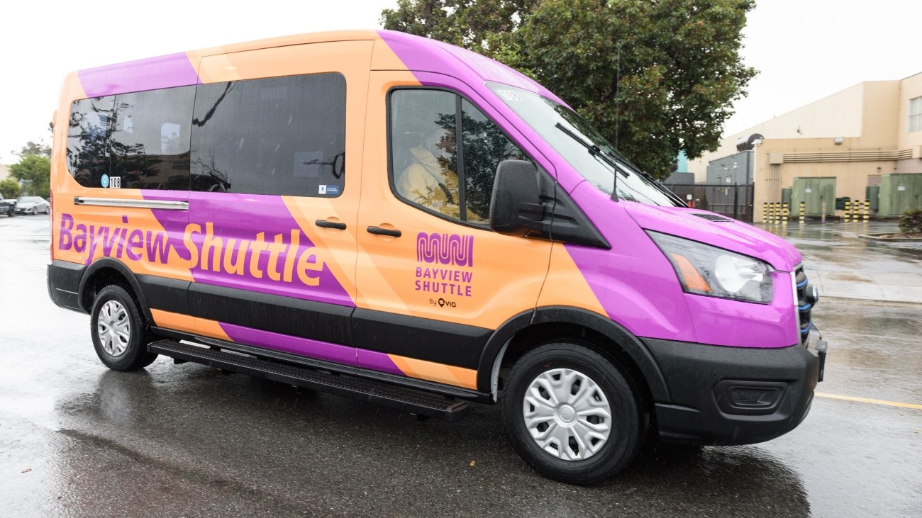 An orange and purple shuttle vehicle with Bayview Shuttle branding