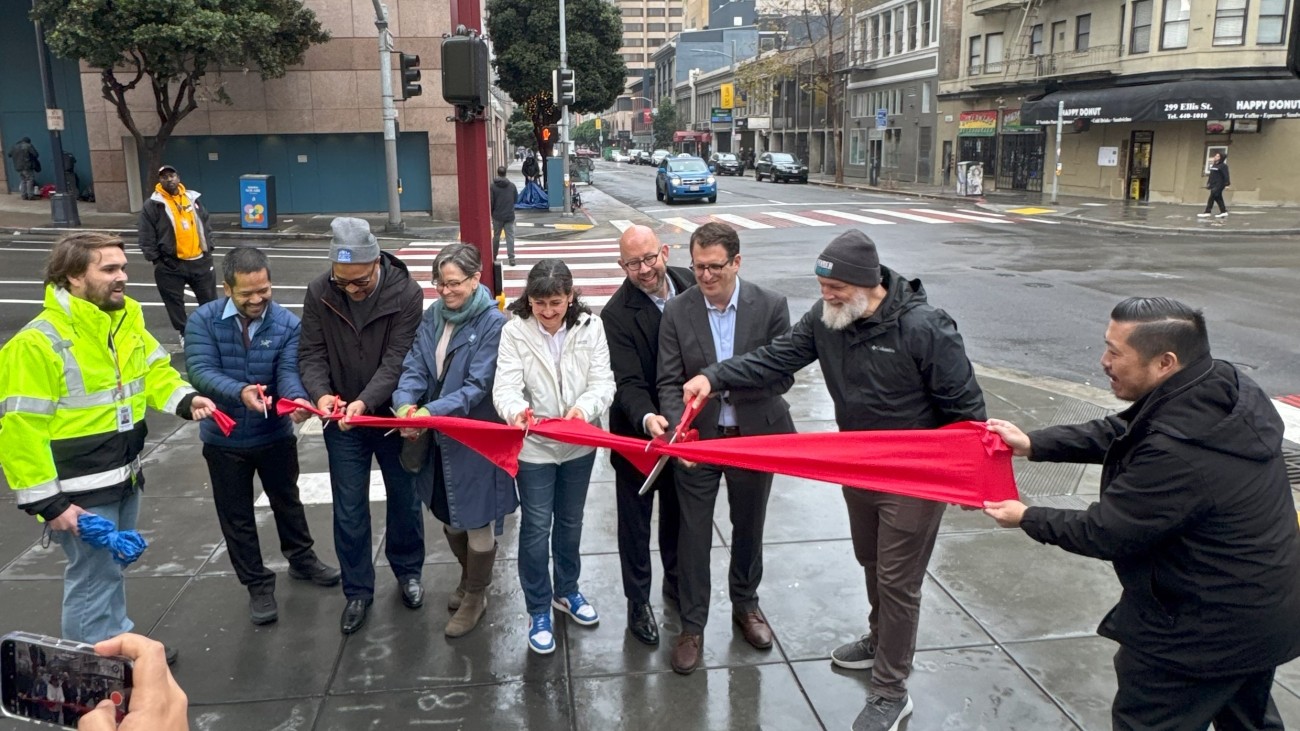 Staff cutting a ribbon for the completion of the Safer Taylor Street project