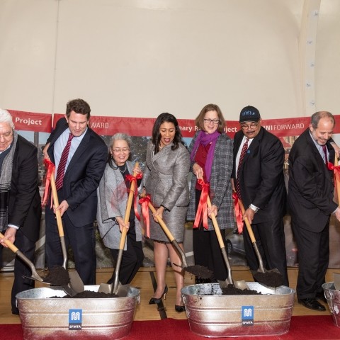Elected officials digging shovels into dirt at the Geary groundbreaking