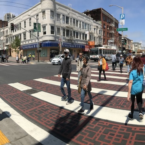 People crossing the street in a new crosswalk in Chinatown 