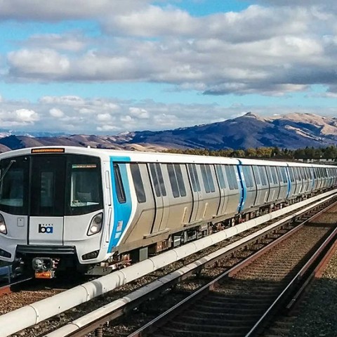 New bart train pulling in to a station