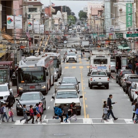 people walking across a street in Chinatown
