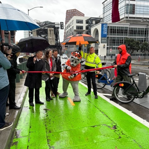 Lou Seal and officials open new protected bike lane on 3rd Street near Berry Street. 
