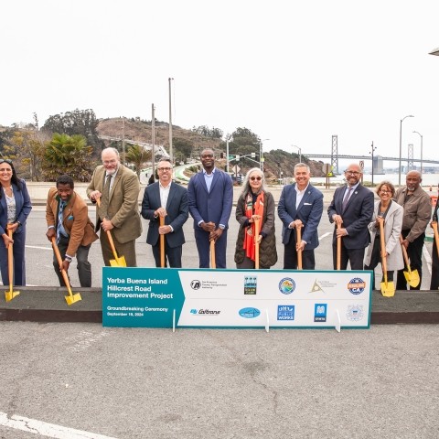 Transportation officials, community leaders and staff posing for a photo with shovels