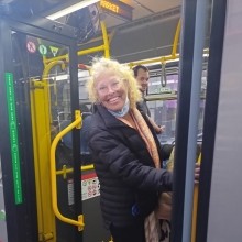 Transit rider stands at the entrance to the 49 Muni bus. 