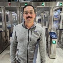 Transit rider in front of fare gates at Powell Station 